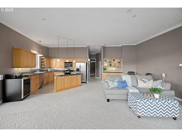 a kitchen with stainless steel appliances kitchen island granite countertop a refrigerator and stove