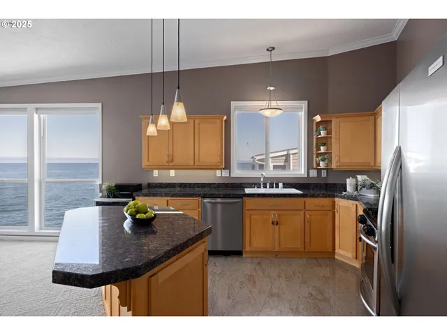 a kitchen with a sink appliances and cabinets