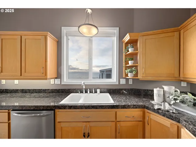 a kitchen with granite countertop a sink and a window
