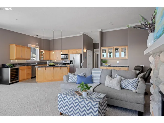 a living room with furniture and kitchen view