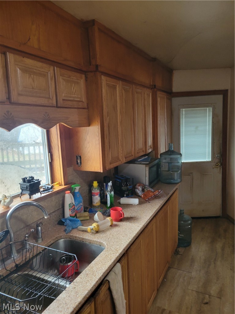 13989 Diagonal Road Salem, OH 44460 - Photo 10 of 18 Kitchen with light stone counters, sink, and light wood-type flooring