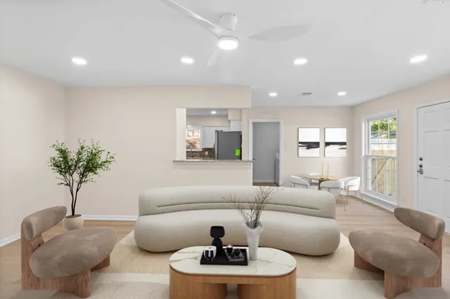 a living room with furniture and a large window