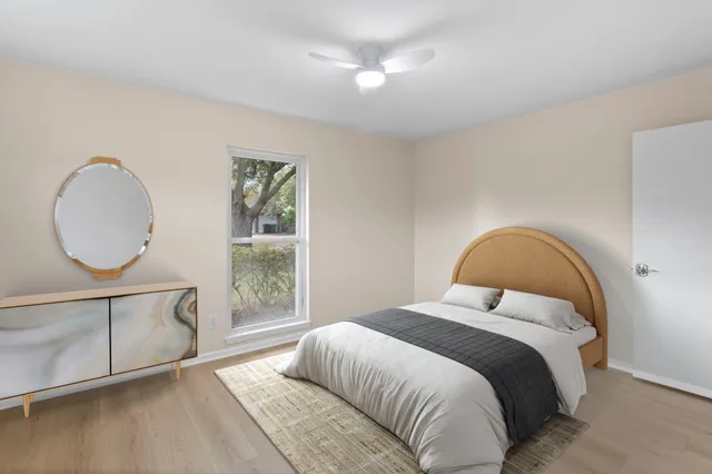 a bedroom with a large bed and a window