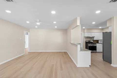 a view of kitchen with refrigerator microwave and stove