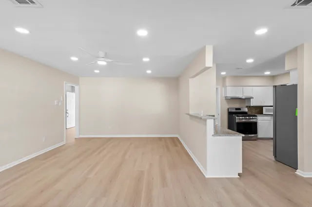 a view of kitchen with refrigerator microwave and stove