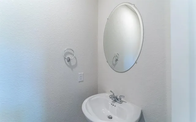 a bathroom with a sink and mirror