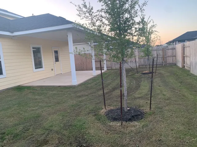 a backyard of a house with table and chairs