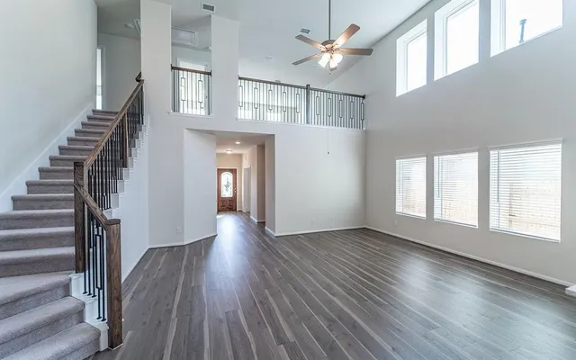 wooden floor in an empty room with a window and wooden floor