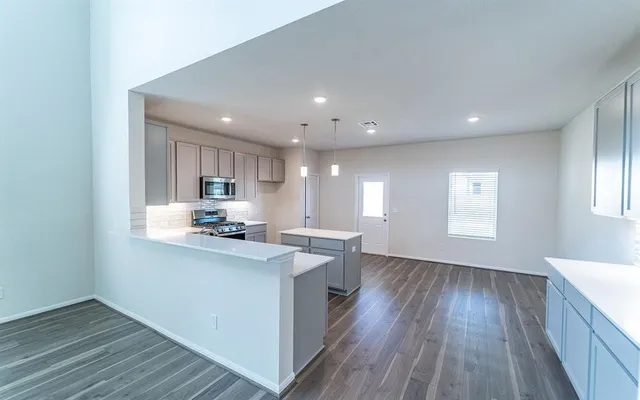 a kitchen with a sink microwave and cabinets