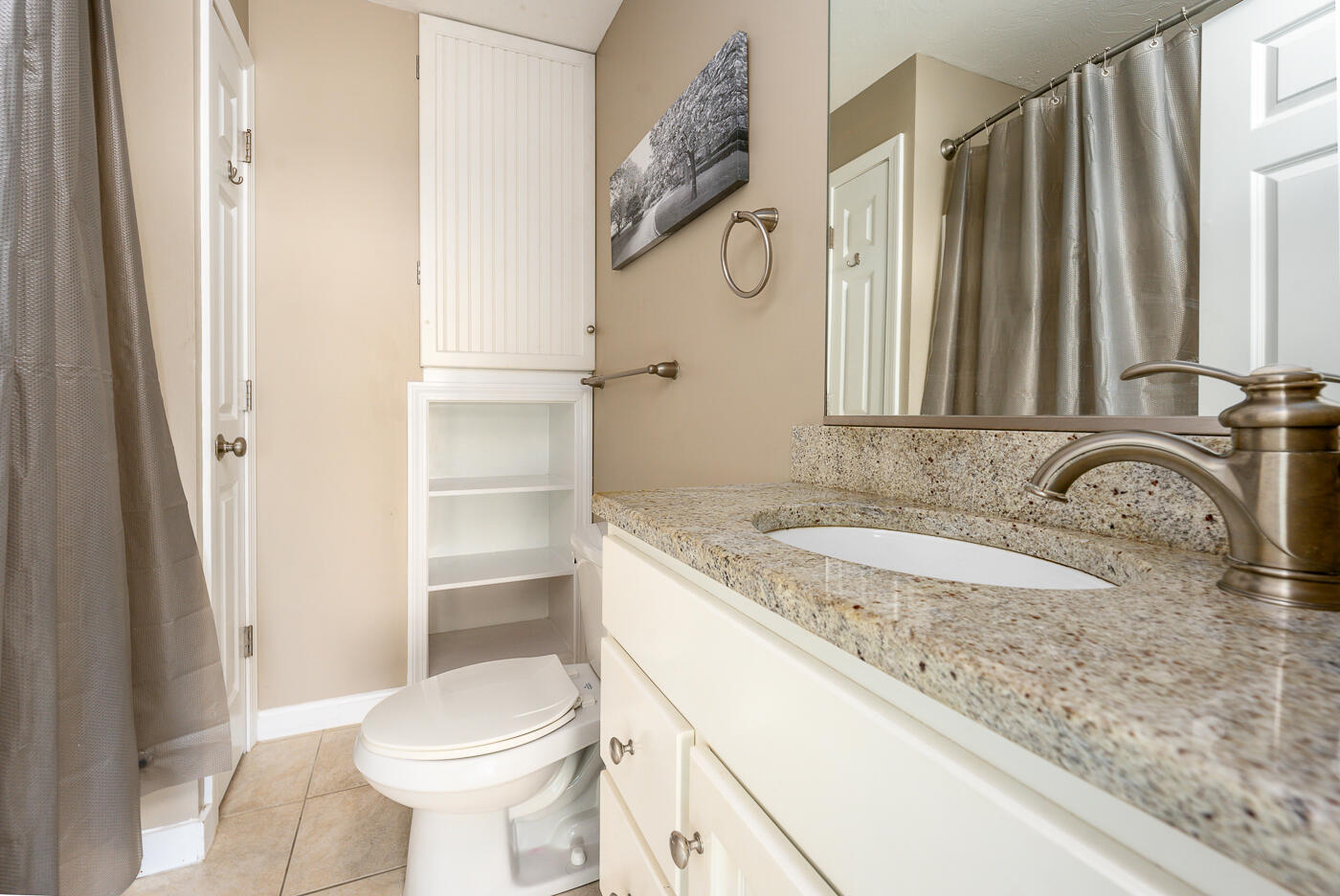 482 Shore Road, Unit 19 Truro, MA 02666 - Photo 11 of 17 a bathroom with a granite countertop sink toilet and a mirror