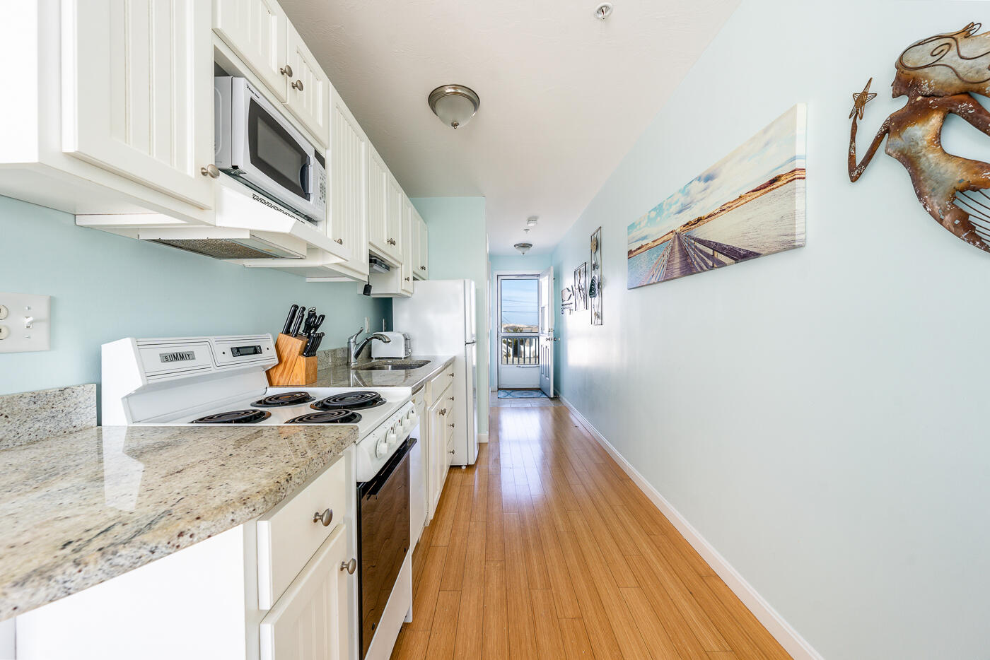 482 Shore Road, Unit 19 Truro, MA 02666 - Photo 8 of 17 a kitchen with stainless steel appliances granite countertop a sink and stove
