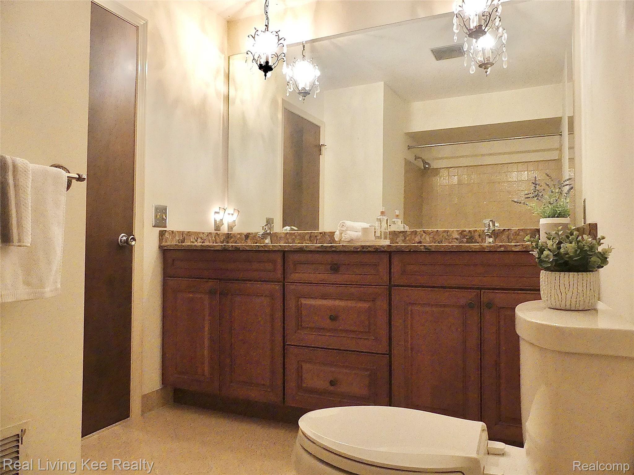 5165 Glengate Road Rochester, MI 48306 - Photo 18 of 38 Full bath with double sinks, updated cabinetry and granite countertop