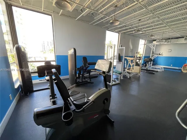 a room with gym equipment and a large window