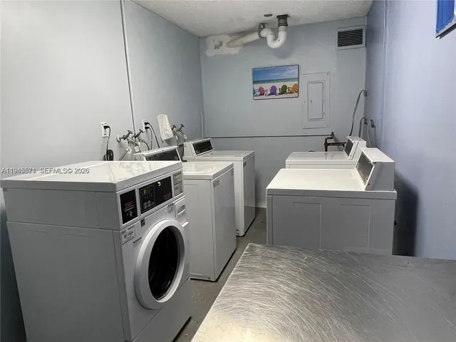 a bathroom with a sink and a washer dryer