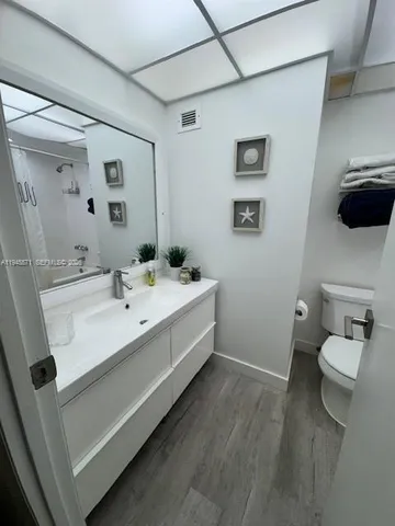 a bathroom with a sink double vanity and a toilet