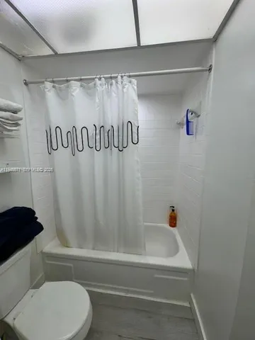 a bathroom with a shower and a toilet