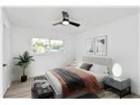 a bedroom with a bed and a potted plant