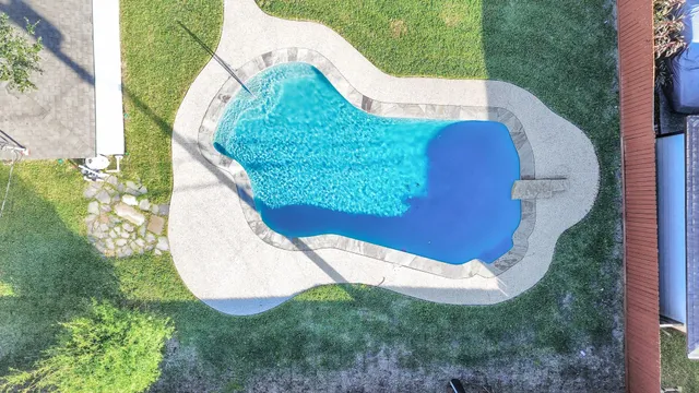an aerial view of a house with a swimming pool