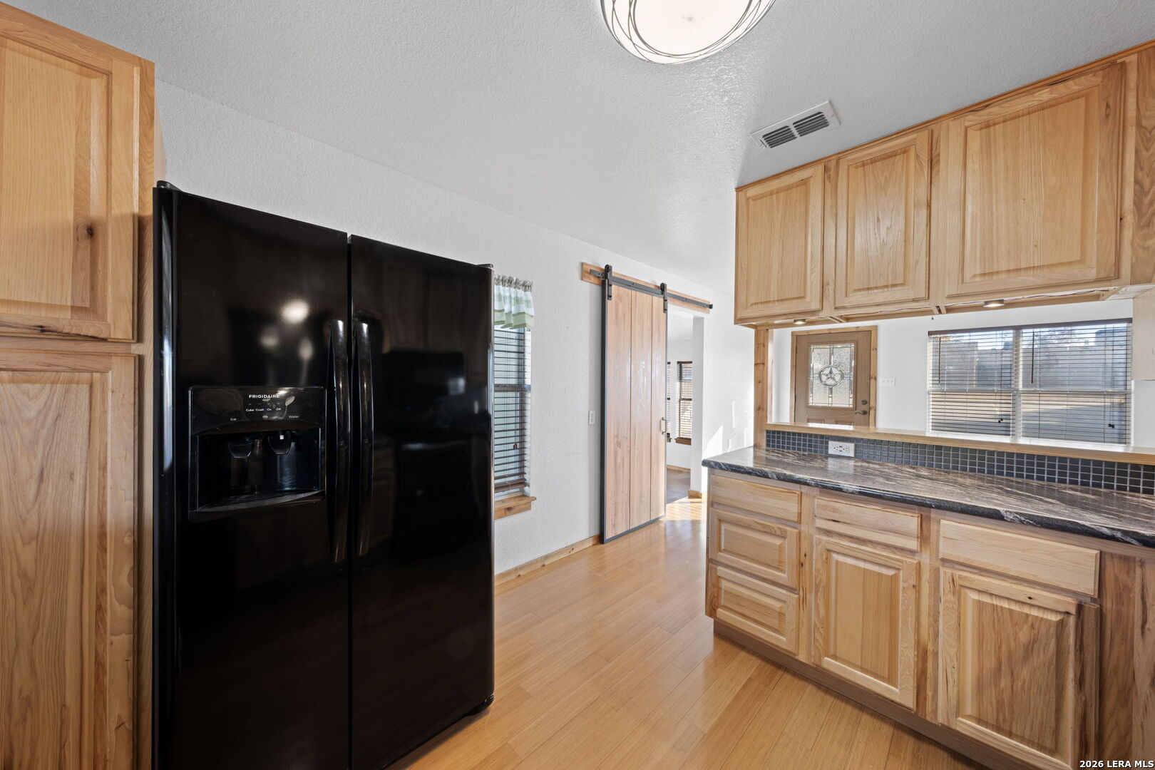 105 Avenue A Center Point Center Point, TX 78010 - Photo 11 of 30 a kitchen with granite countertop stainless steel appliances a refrigerator and cabinets