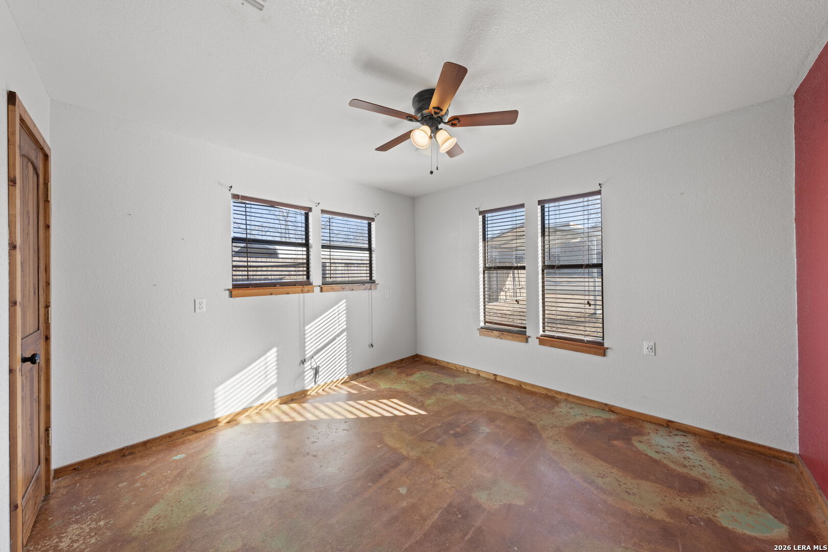 105 Avenue A Center Point Center Point, TX 78010 - Photo 12 of 30 an empty room with windows and ceiling fan