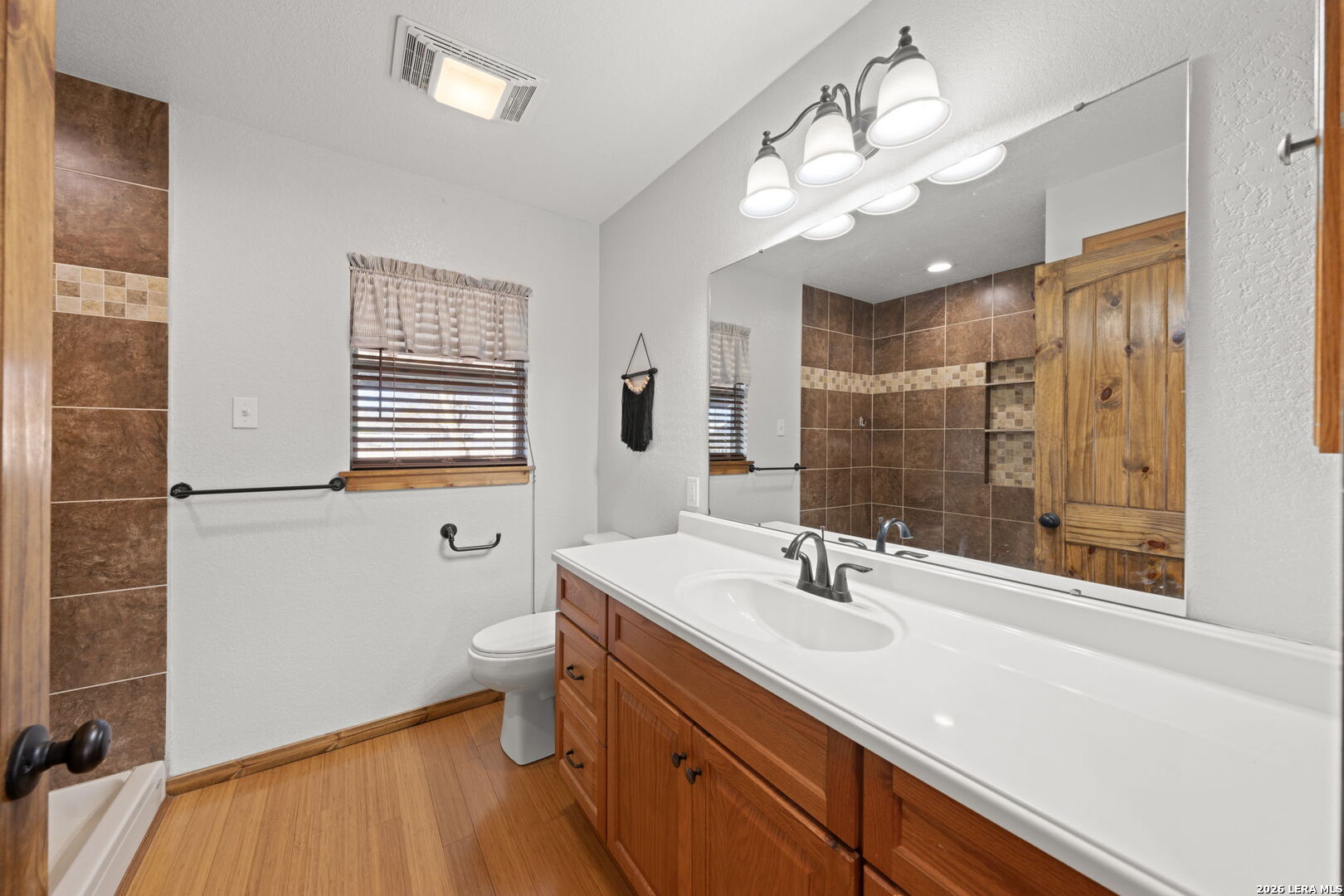 105 Avenue A Center Point Center Point, TX 78010 - Photo 17 of 30 a bathroom with a sink a toilet and a mirror