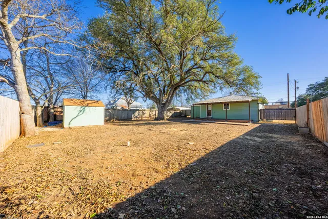 a view of yard covered with snow in front of house