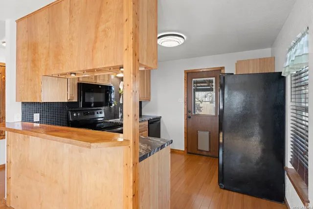a kitchen with stainless steel appliances a refrigerator and a stove top oven