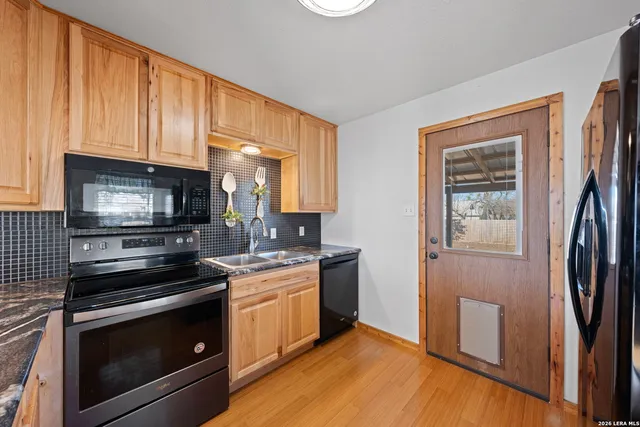 a kitchen with stainless steel appliances a stove microwave and sink
