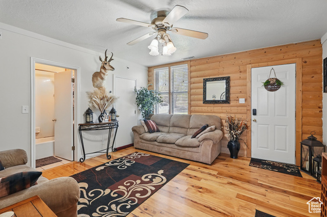 2490 South State Street Springville, UT 84663 - Photo 30 of 38 Living area with a textured ceiling, rustic walls, light wood-style floors, ceiling fan, and visible vents