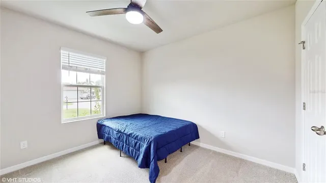 a bedroom with a bed and window