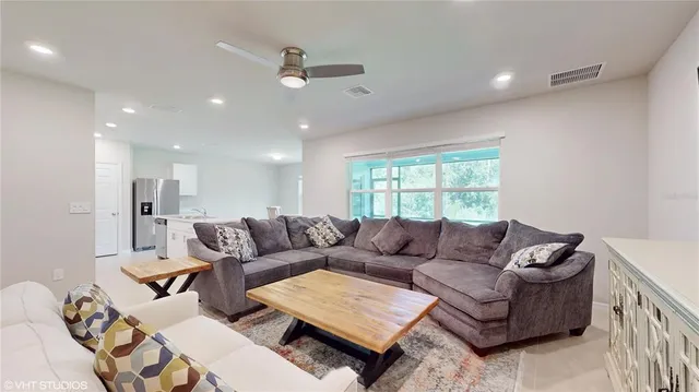 a living room with furniture and a large window