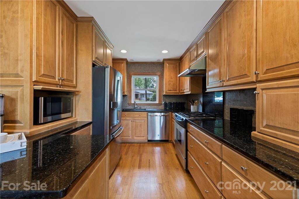 4223 Chelmsford Road Charlotte, NC 28211 - Photo 11 of 33 a kitchen with stainless steel appliances granite countertop a stove a sink and a refrigerator