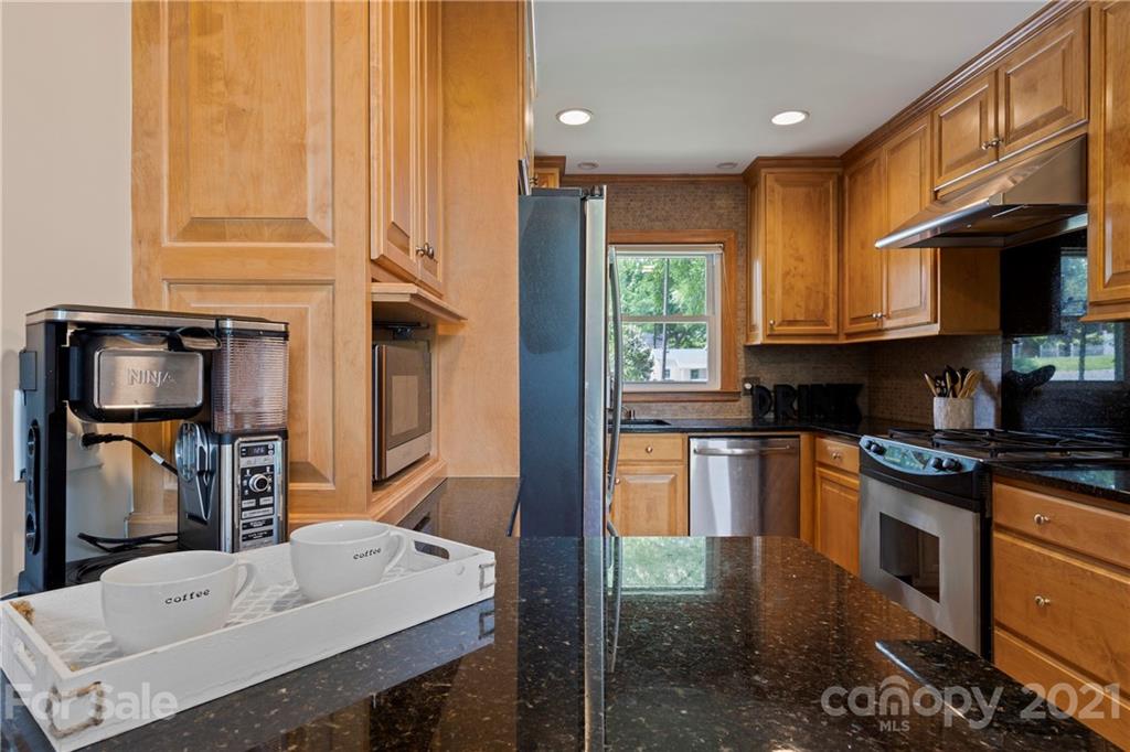 4223 Chelmsford Road Charlotte, NC 28211 - Photo 13 of 33 a kitchen with a sink cabinets and a stove top oven