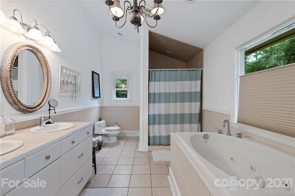 4223 Chelmsford Road Charlotte, NC 28211 - Photo 20 of 33 a bathroom with a double vanity sink a toilet and shower
