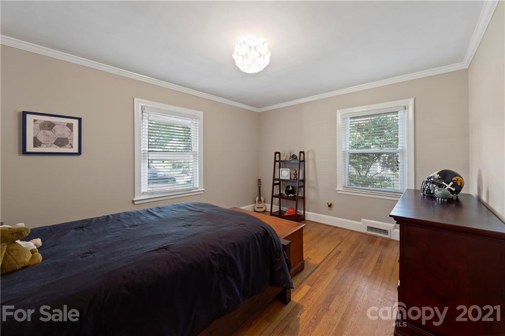 4223 Chelmsford Road Charlotte, NC 28211 - Photo 22 of 33 a bed sitting in a bedroom next to a window