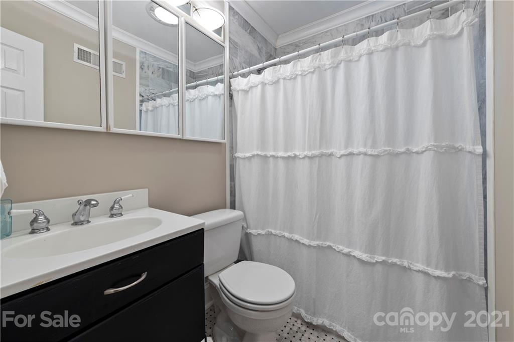 4223 Chelmsford Road Charlotte, NC 28211 - Photo 23 of 33 a bathroom with a sink a toilet and shower curtain