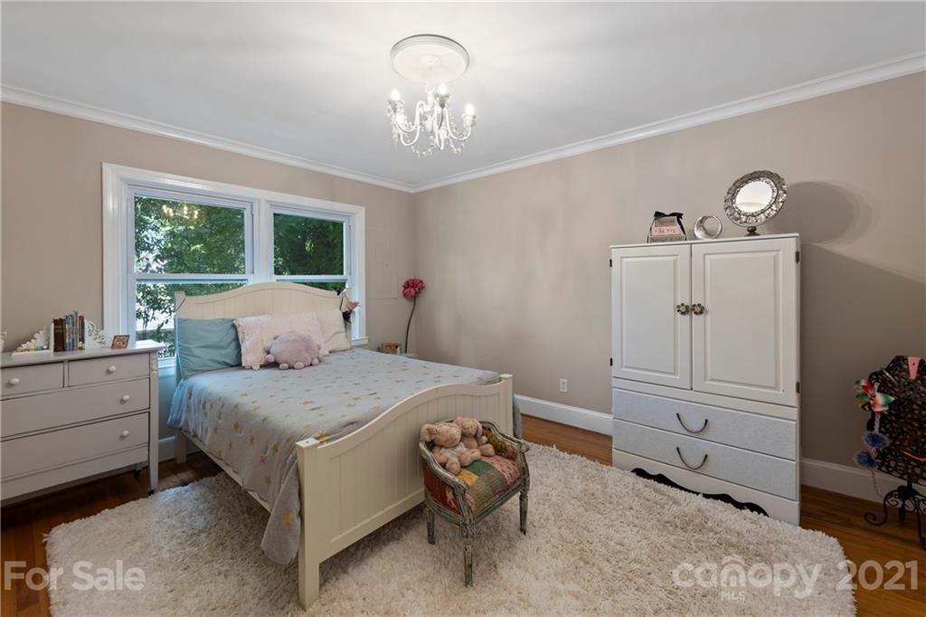 4223 Chelmsford Road Charlotte, NC 28211 - Photo 24 of 33 a bedroom with a bed and wooden floor