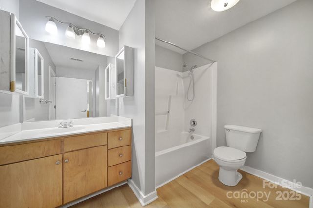 a bathroom with a sink toilet vanity and shower