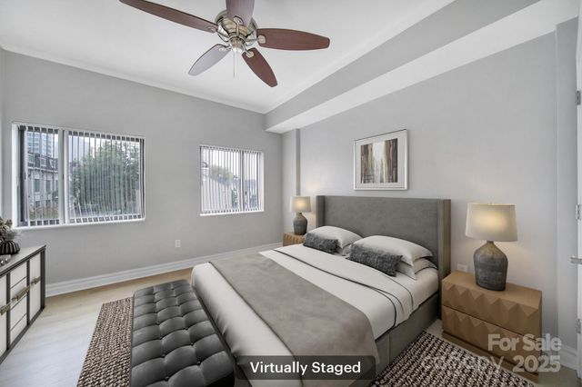 an empty room with windows and fan