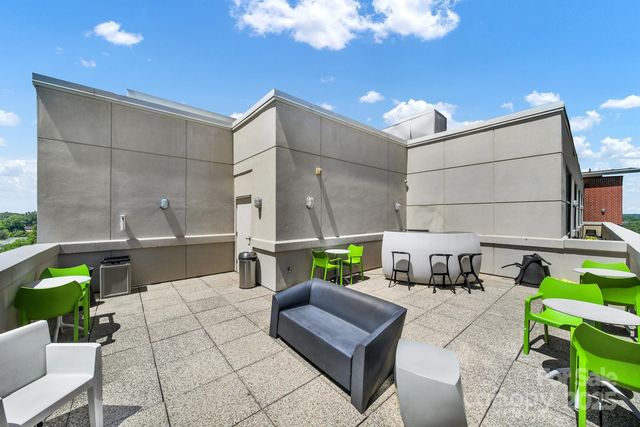 a view of swimming pool with outdoor seating and city view