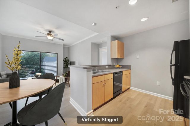 a kitchen with a table chairs stove and refrigerator