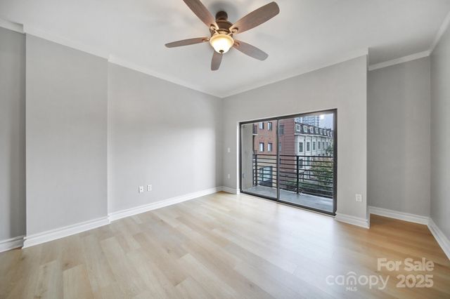 a view of a room with a window and a ceiling fan