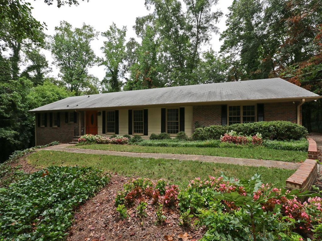 2740 Ridge Valley Road Northwest Atlanta, GA 30327 - Photo 1 of 1 a front view of a house with a garden