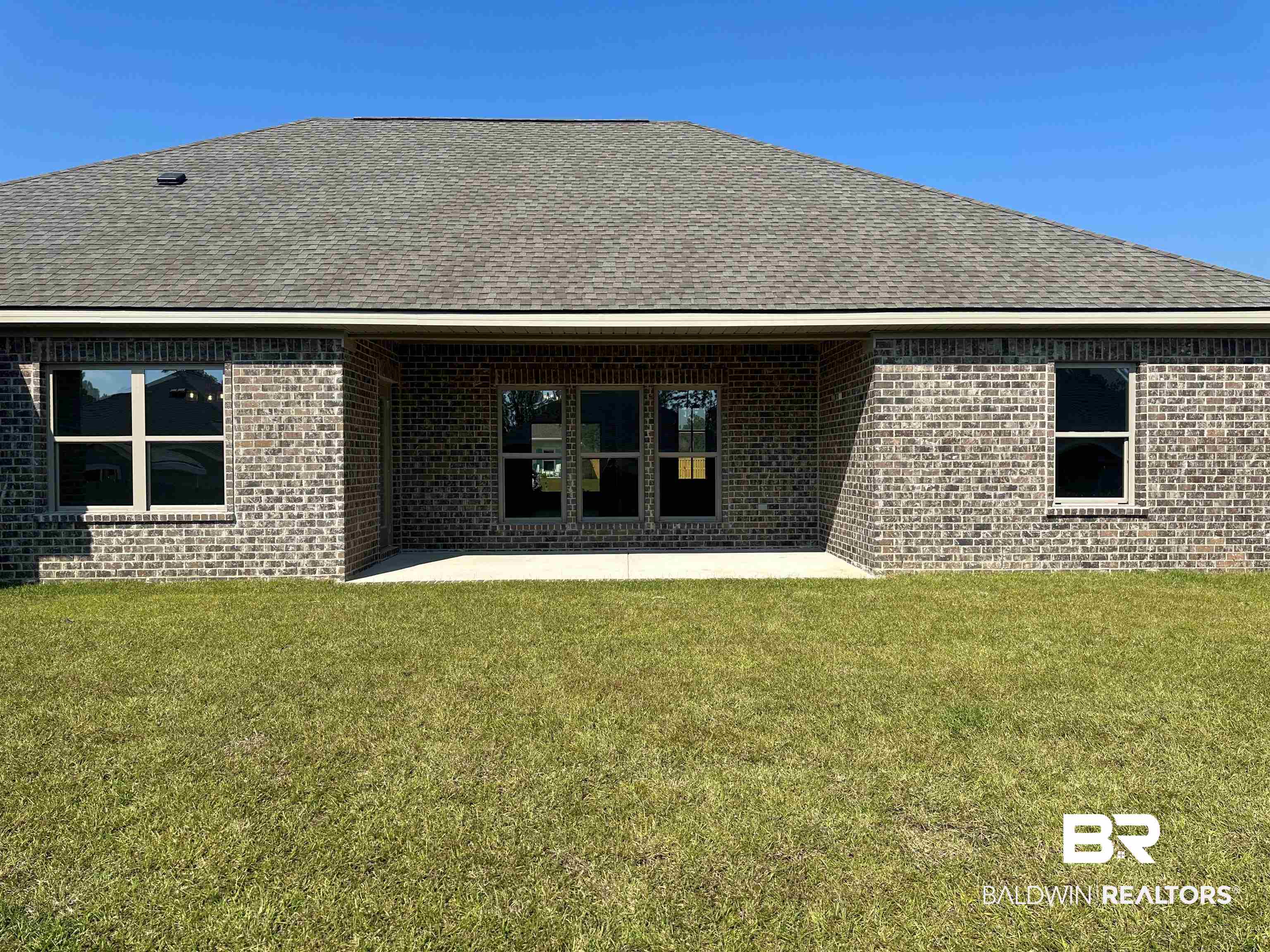 23548 Travis Stock Street, Unit 50 Foley, AL 36535 - Photo 5 of 30 Back of property with a patio and a lawn