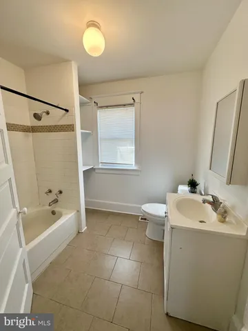 a bathroom with a sink toilet tub and shower