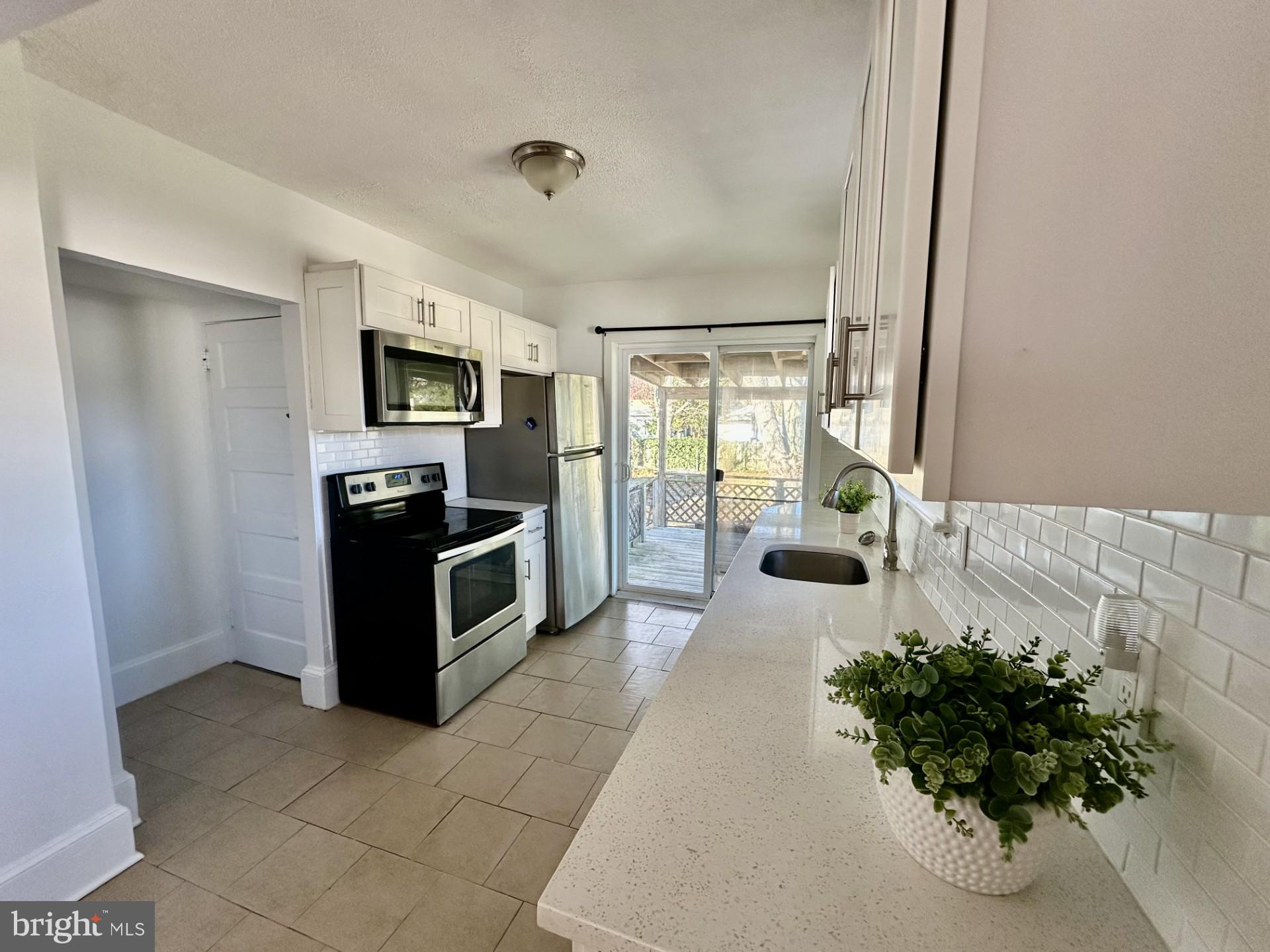 139 Otis Avenue Tuckerton, NJ 08087 - Photo 10 of 27 a living room with stainless steel appliances furniture a rug and a view of kitchen