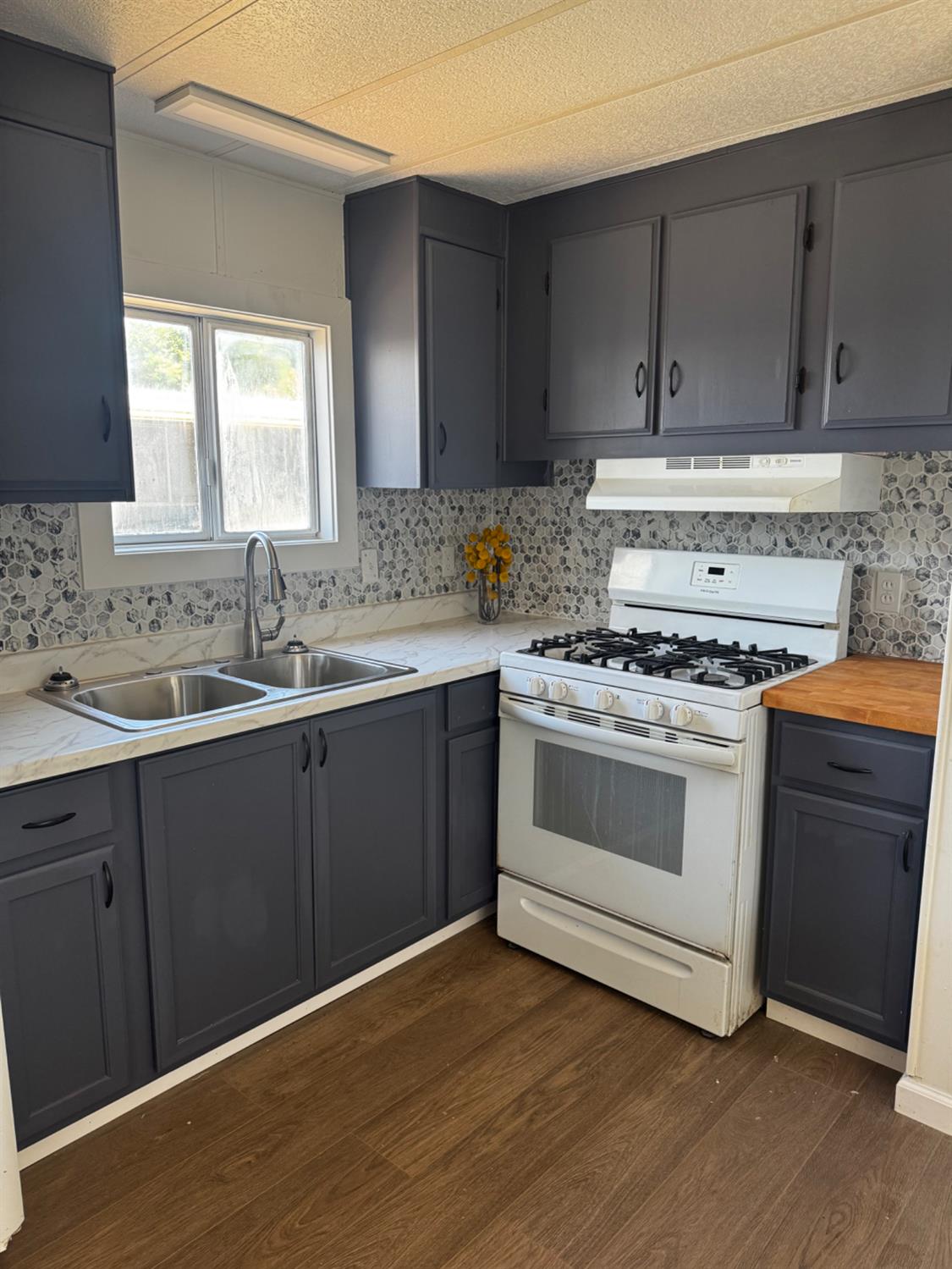 1200 South Carpenter Road, Unit 51 Modesto, CA 95351 - Photo 13 of 20 a kitchen with a sink stove and cabinets