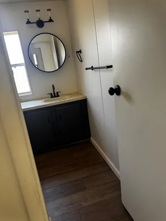 a bathroom with a sink mirror vanity and toilet