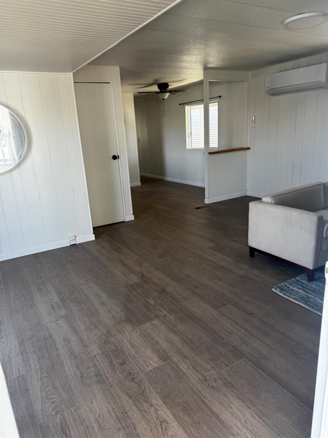 1200 South Carpenter Road, Unit 51 Modesto, CA 95351 - Photo 6 of 20 an empty room with wooden floor and windows