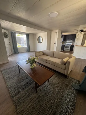 a living room with furniture and wooden floor